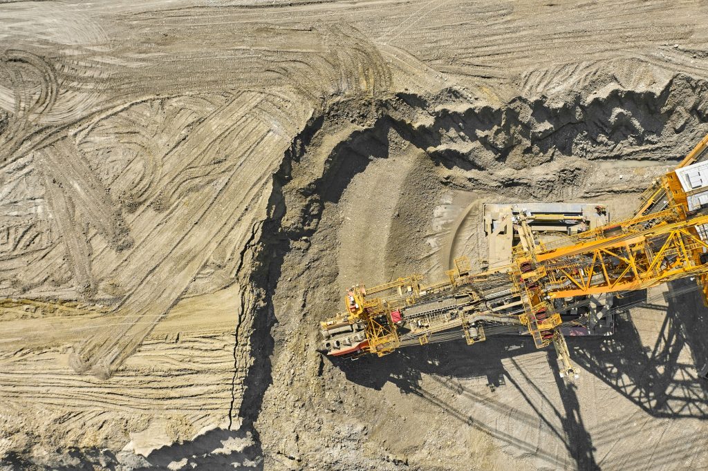 Aerial view of large heavy equipment machine mining natural resource. Coal mining by bucket wheel