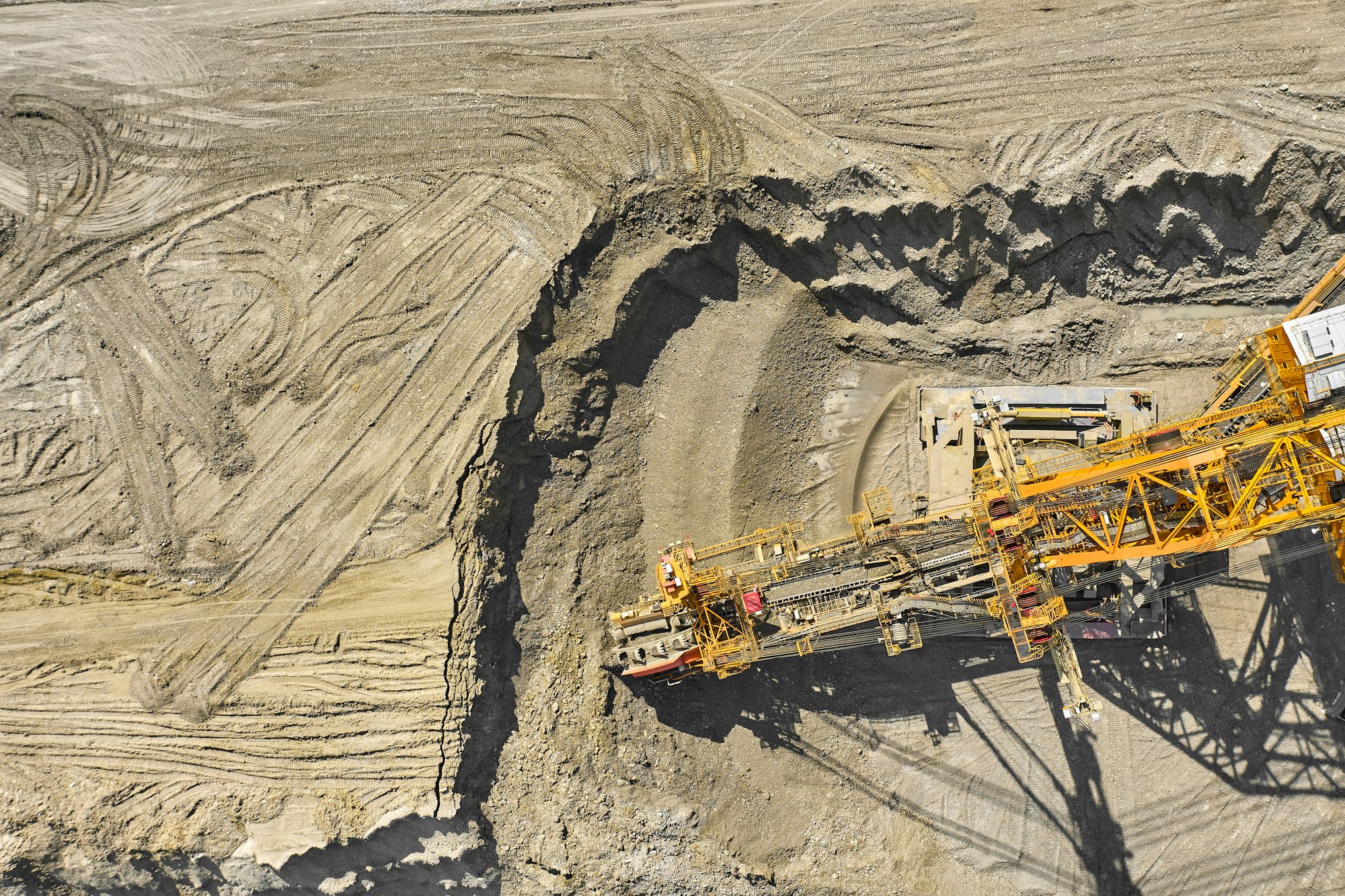 Aerial view of large heavy equipment machine mining natural resource. Coal mining by bucket wheel