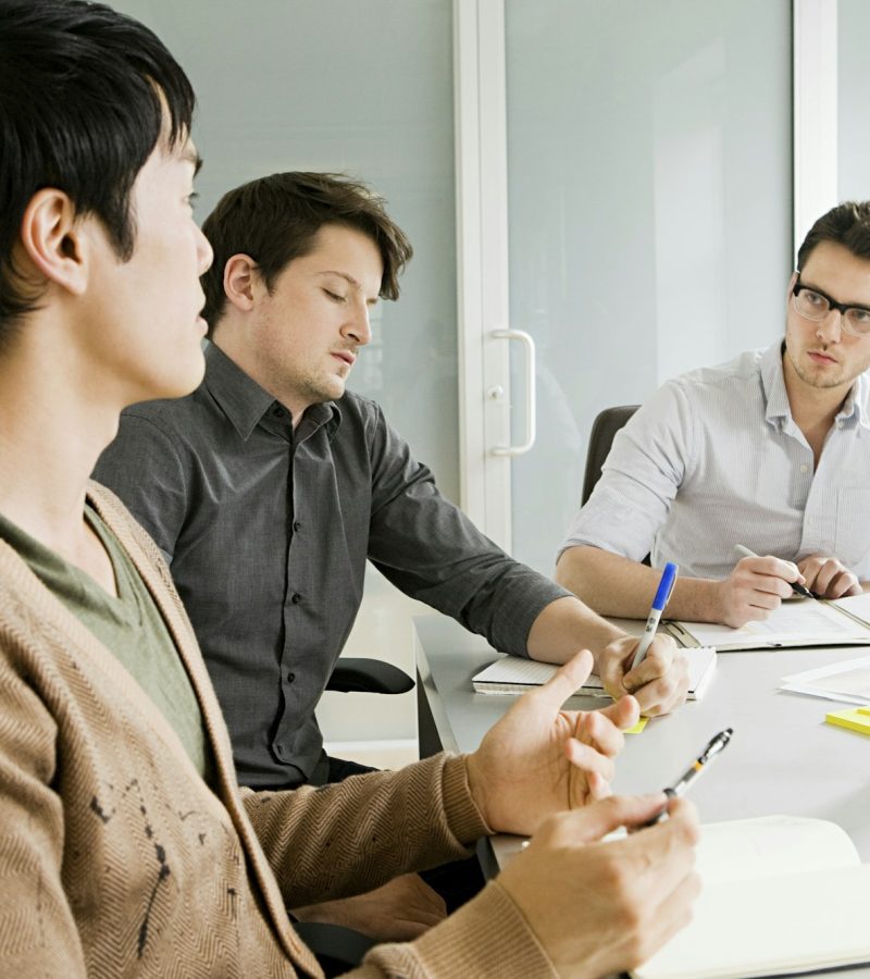Young men meeting in office